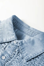 Light blue denim dress featuring a smocked collared neck and subtle smocked detailing around the placket