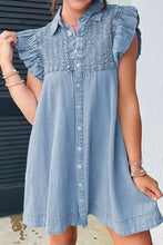 Light blue denim dress with smocked collared neck, ruffled cap sleeves, and button-down front