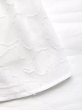 White lace fabric with raised floral patterns on Smocked Crop Top Set