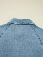 Light-wash denim shirt mini dress with classic collar smocked cuffs and visible stitching detailing