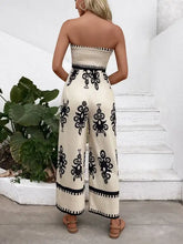 Beige and black smocked printed wide leg jumpsuit with embroidered strapless top