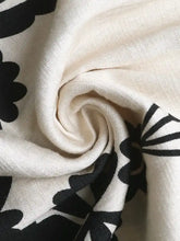 Smocked printed wide leg jumpsuit with off-white scarf and black floral patterns