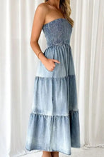 Strapless smocked tube slit tiered denim dress in faded blue with subtle texture and a maxi length