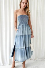Strapless smocked tube slit tiered denim dress with midi length and side slit in classic blue denim