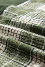 Green plaid shacket fabric with white and black accents, laid flat