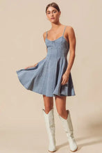 A light-wash denim mini dress with thin spaghetti straps and a flared skirt from the so me a line fit and flare collection