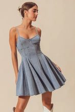 A light blue denim mini dress with thin straps and flared skirt in so me a line fit and flare denim mini dress style
