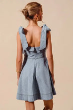 Light blue denim dress with diamond bow ribbon details at the shoulders and a back zipper closure