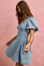 A light blue SO ME mini dress in denim with puffed bubble sleeves and a flared fit and flare skirt