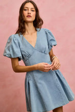 A light blue denim fit and flare mini dress with bubble sleeves denim and a flared skirt