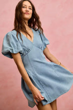 A light blue bubble sleeves denim fit and flare mini dress with puffed short sleeves and a v-neckline