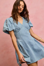 A light blue bubble sleeves denim fit and flare mini dress with puffed short sleeves and a v neckline