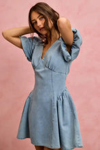 A light blue denim mini dress featuring bubble sleeves and a flared skirt in the so me bubble sleeves denim style