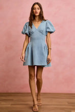 A light blue bubble sleeves denim mini dress with puffed short sleeves and a flared skirt from so me