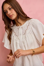 White cotton gauze blouse with delicate lace trim and soft flutter sleeves for a feminine look