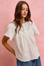 White cotton gauze blouse with lace trim and flutter sleeves featuring a button-front design