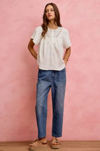 White cotton gauze blouse with flutter sleeves and lace trim featuring textured sheer fabric and delicate neckline lace detailing