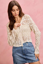 Cream-colored crochet knit cardigan sweater with long sleeves