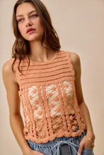 A peach-colored sleeveless crochet knitted lace sweater tank top with intricate floral patterns and scalloped hem