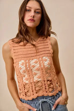 A peach-colored sleeveless crochet knitted lace sweater tank top with intricate lace patterns and a scalloped hem