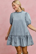 A light wash denim dress with puffed short sleeves and a tiered hem from SO ME collection in light wash denim