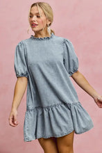 Light wash denim dress with puffed sleeves and ruffled hem in a short sleeves mini tiered design