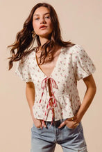 Off-white ditsy floral print gauze blouse with short flutter sleeves and red tie front from so me collection