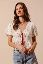 Delicate off-white ditsy floral print gauze blouse with flutter sleeves and red tie-front v-neckline by SO ME