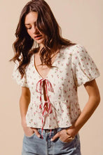 A delicate off-white SO ME ditsy floral print gauze blouse with short flutter sleeves and a tied-front neckline