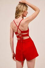 Back view of SO ME game day romper with red strappy crisscross back