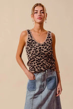A beige and black leopard knitted lightweight v neck tank top made of knit fabric for casual wear