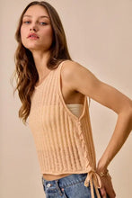 Beige low gauge pointelle sweater tank top with ribbed knit texture and side tie details for lightweight wear