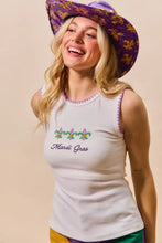 White sleeveless tank top with embroidered purple green fleur-de-lis and mardi gras text with contrast blanket stitch trim