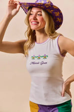 White sleeveless tank top with purple trim and contrast blanket stitch featuring embroidered mardi gras fleur-de-lis design