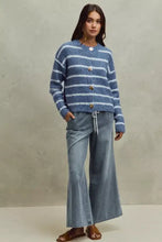 Blue and white striped fuzzy knit cardigan with gold buttons paired with mid rise elastic waist flare jeans