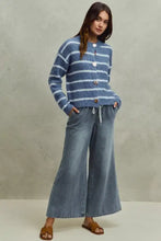Blue and white striped knit cardigan with decorative buttons paired with so me mid rise elastic waist flare jeans