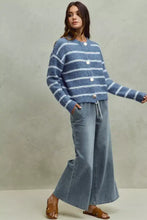 Blue and white striped knit cardigan with button closures paired with mid rise elastic waist flare jeans