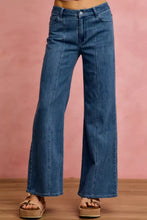 Blue denim jeans featuring a mid rise stretch fit with wide-leg silhouette and classic five-pocket design
