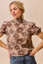 Brown and cream floral mesh lace top with puff sleeves featuring texture floral design and back button closure