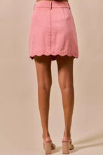 A pink vintage wash denim mini skirt with scalloped hem and front pleats from SO ME collection