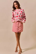 Pink floral knit sweater with red roses and hearts paired with vintage wash pink scallop edge denim mini skirt