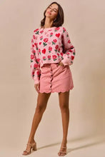 Pink rose and heart patterned knit sweater paired with vintage wash denim mini skirt featuring scallop edge hem