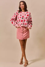 Pink sweater with red roses and hearts embroidered long sleeves and scalloped hem paired with so me vintage wash denim mini skirt