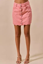 Pink vintage wash denim mini skirt with scalloped hem and front button closure for stylish casual wear