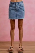 Light-wash washed denim mini skirt with contrast floral pockets frayed hem and front button closure by SO ME