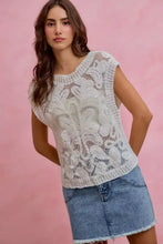 White lace sleeveless top with intricate floral patterns paired with so me washed denim mini skirt with contrast pockets
