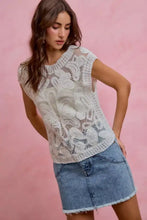 White lace sleeveless top with intricate floral patterns paired with a so me washed denim mini skirt with contrast pockets