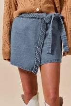 Blue denim skort with wrap braided trimmed waistband and matching tie in soft denim material for stylish wear