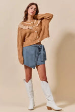 Tan cable knit sweater with delicate lace collar and buttons paired with wrap braided trimmed denim skort