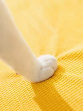 Soft white cat paw on yellow blanket for soft pet stairs